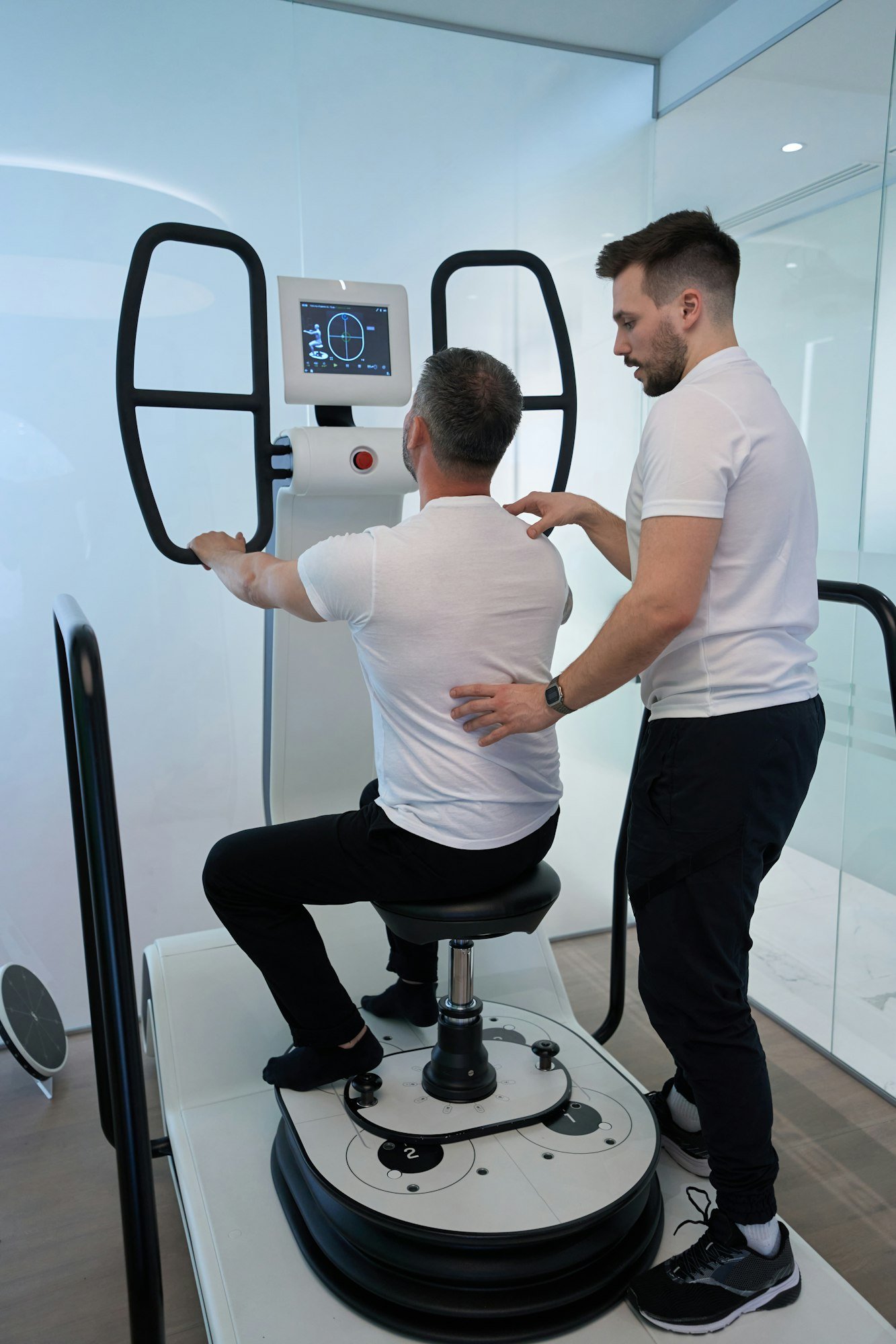 Patient undergoing neuromuscular rehabilitation session with physiotherapist