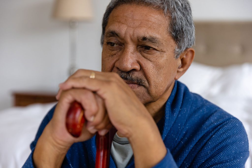 Adult man thinking about Early Detection in Neuromuscular Disorders.