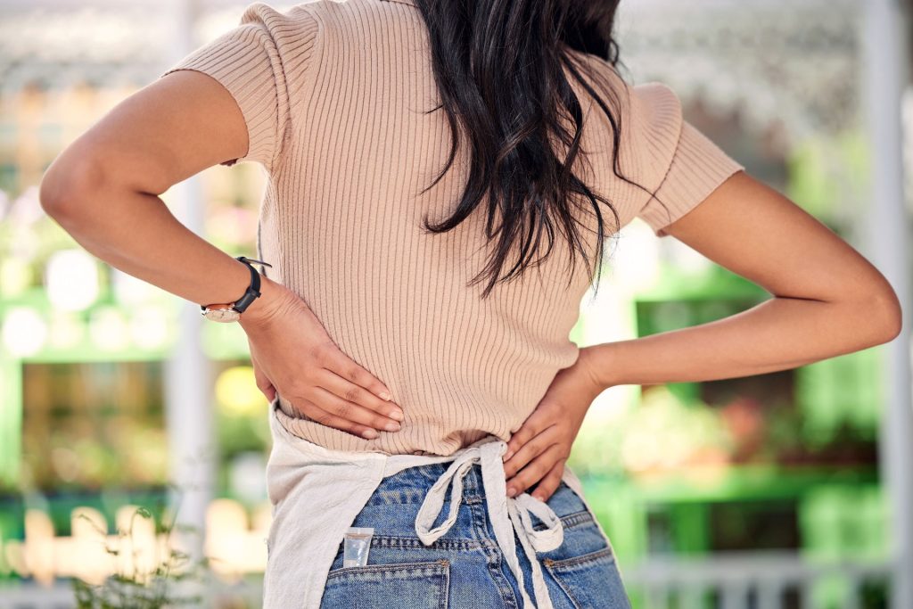 Woman experiencing back pain.