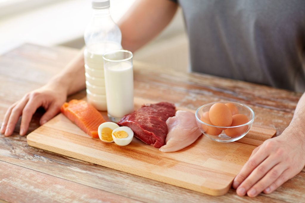 Person with high protein food in his front.