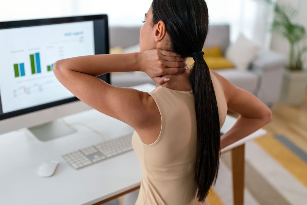 Working woman holding her neck.