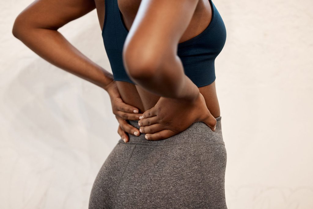 Woman feeling the stress in her spine.