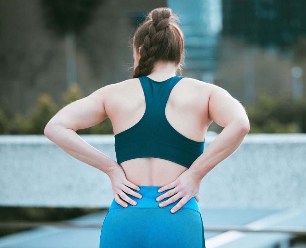 Woman having a lower back pain.