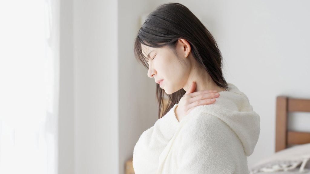 A woman having chronic pain in her shoulder