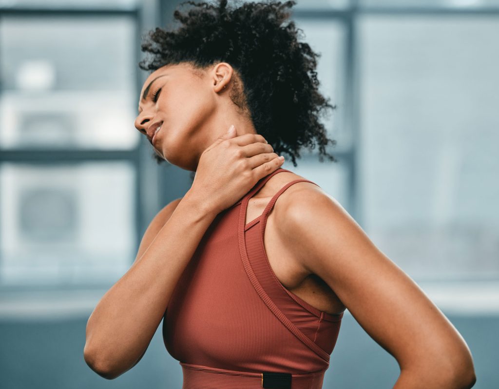 Beautiful fit african-american woman with neck pain.
