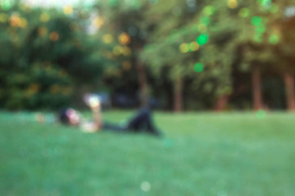 Man in lawn blurry.