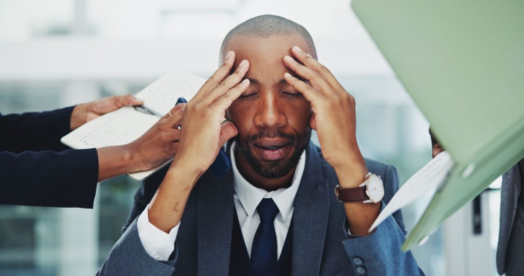 Man with poor mental health stressed at office.