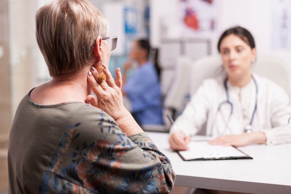 Senior woman with neck pain.