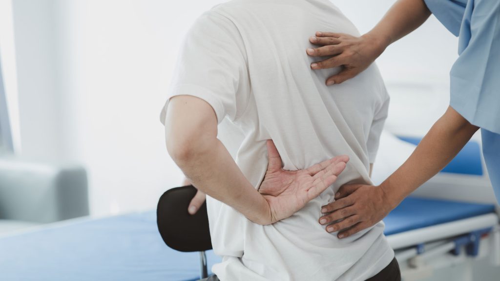 Person with back pain having a check up.