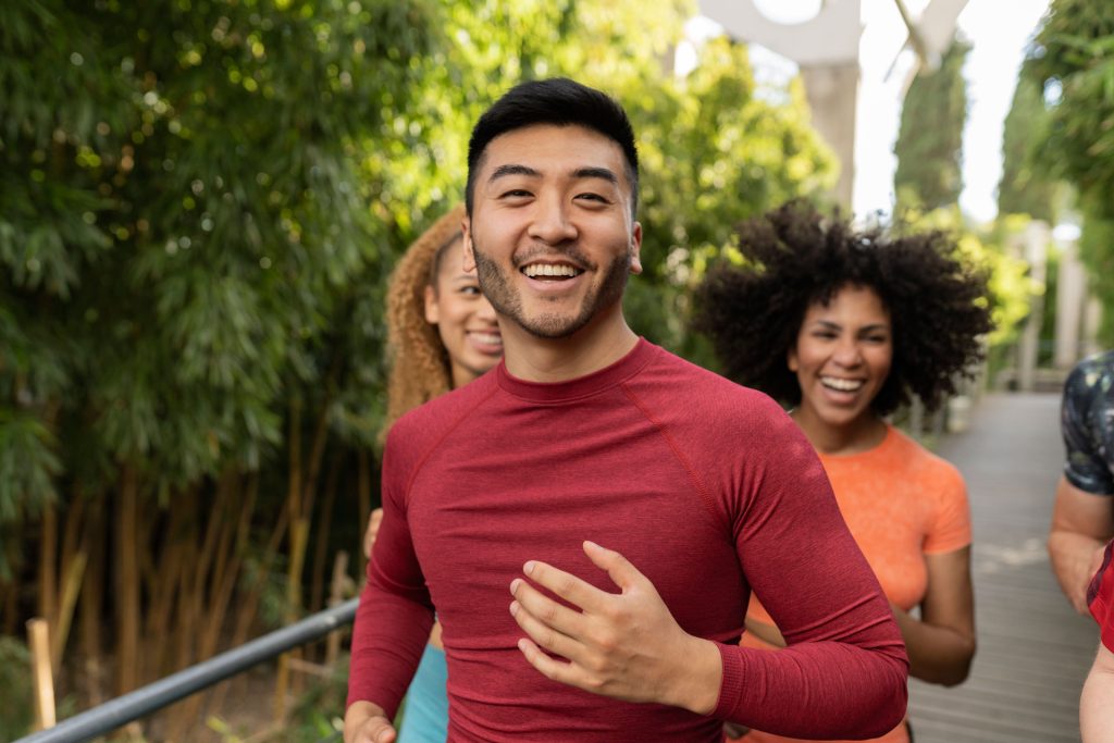 Group of friends running outdoors.