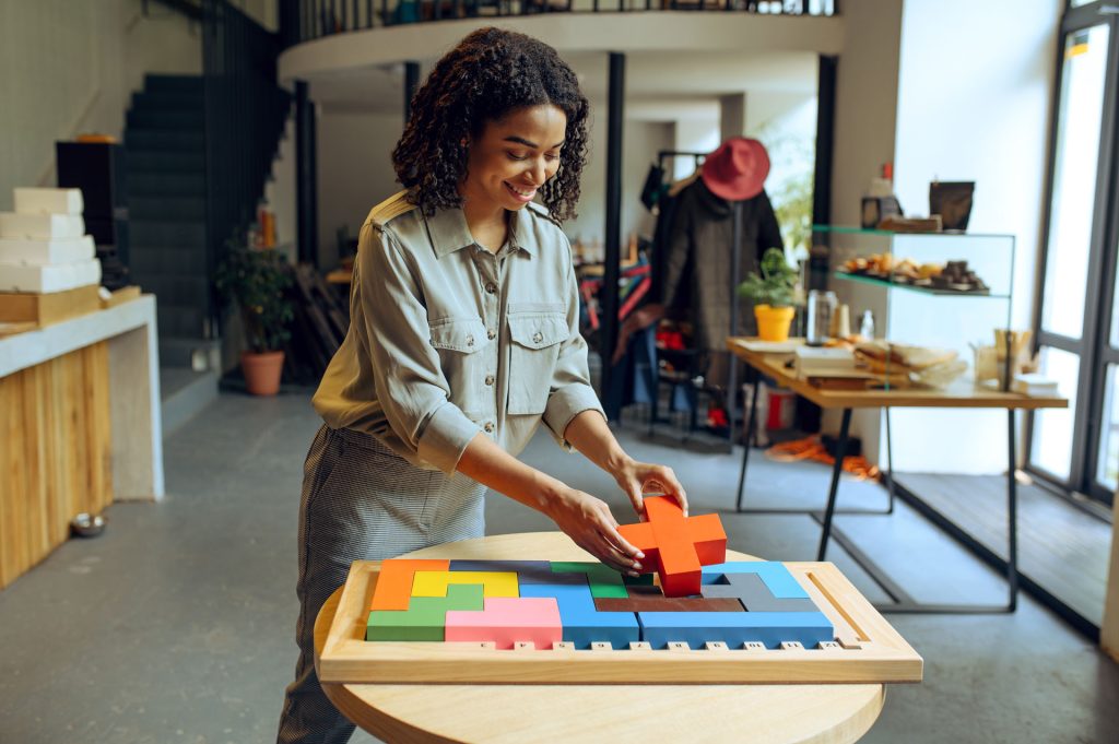 Woman finishing a puzzle in the cafe.