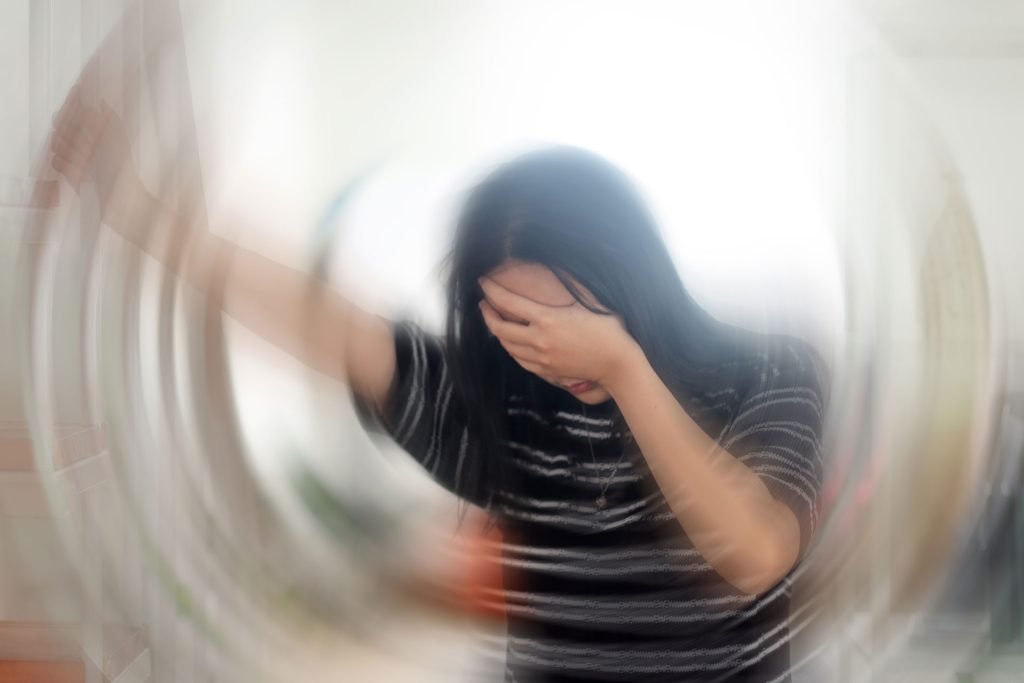 Young woman suffering from chronic dizziness.