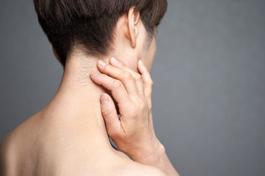 Woman holding her neck.