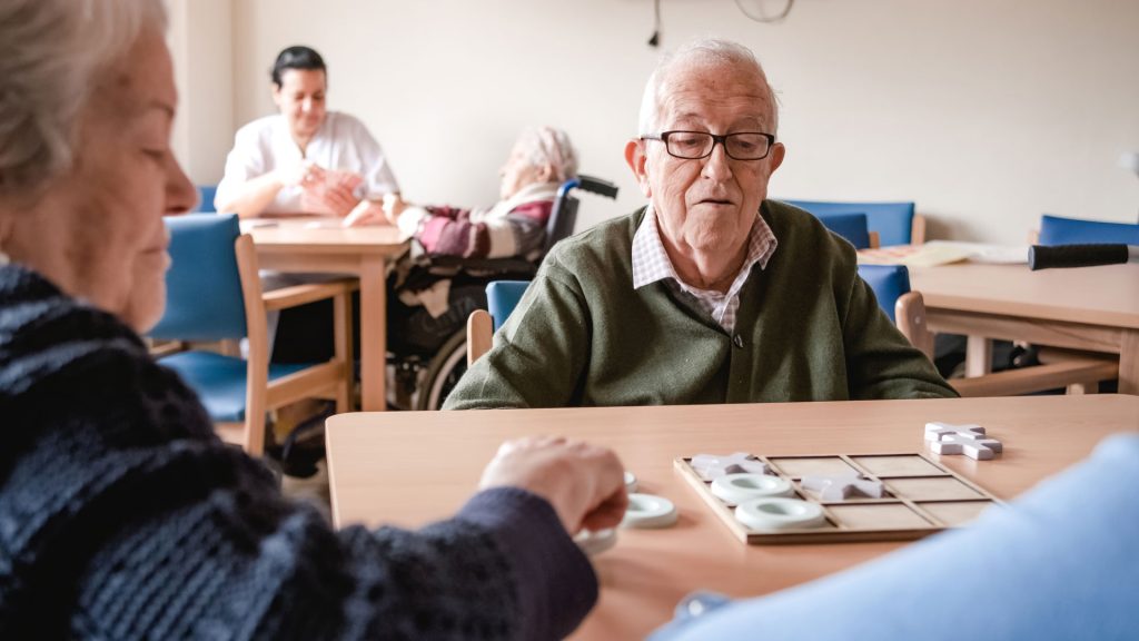 Senior man playing in nursing home.