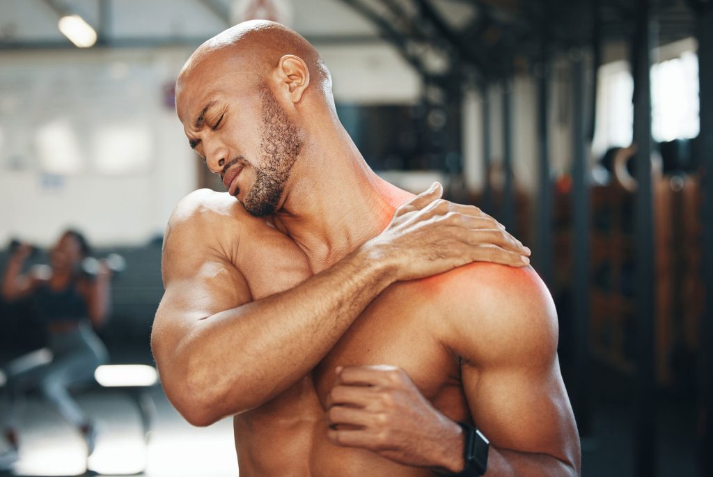 Muscular man with shoulder pain.