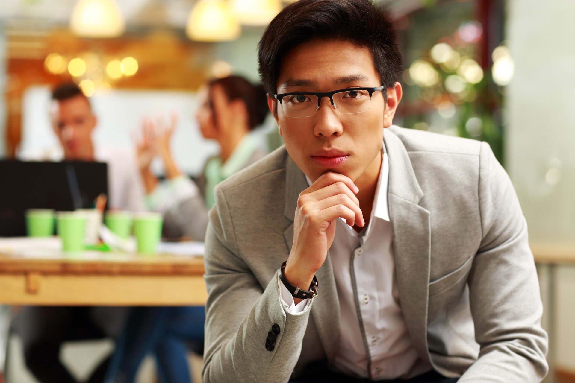 Asian man sitting in office.